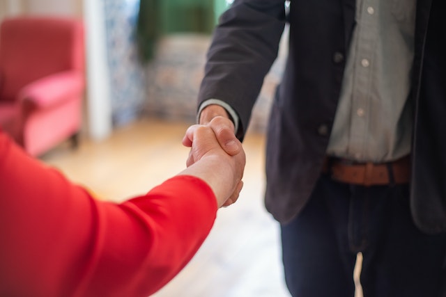 tenant and property manager shaking hands following a screening